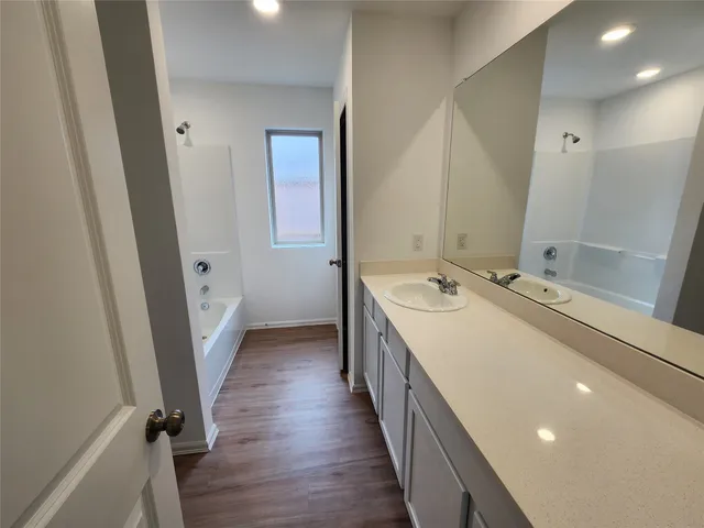 a bathroom with sink a mirror and a shower