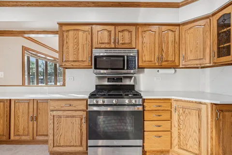 a kitchen with stainless steel appliances granite countertop a refrigerator and cabinets