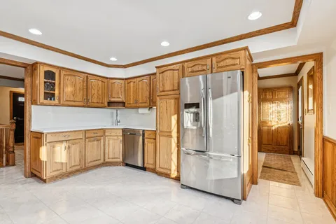 a kitchen with stainless steel appliances granite countertop a refrigerator and stove