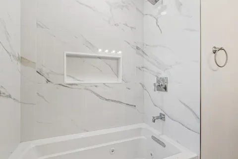 a bathroom with a bathtub and a shower