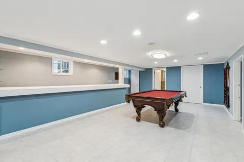 a view of kitchen with kitchen island wooden floor and window