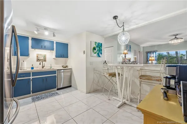 a kitchen with cabinets and chairs