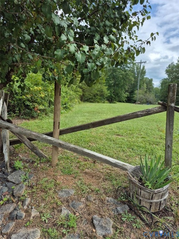 1586 Signboard Road Bumpass, VA 23024 - Photo 1 of 3 Expansive grassy area with a rustic wooden fence a