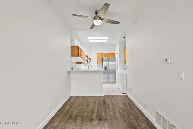 a view of kitchen with sink and wooden floor