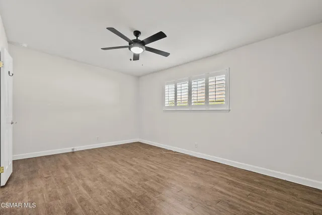 a view of a big room with wooden floor and windows in a room