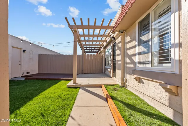 a swimming pool with yard in front of it