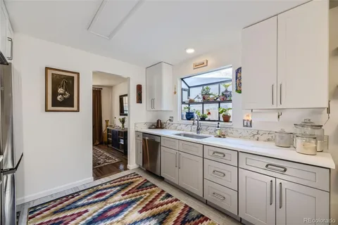 a spacious bathroom with a double vanity sink a mirror and a window