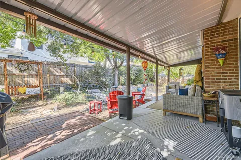 a view of a house with backyard and sitting area