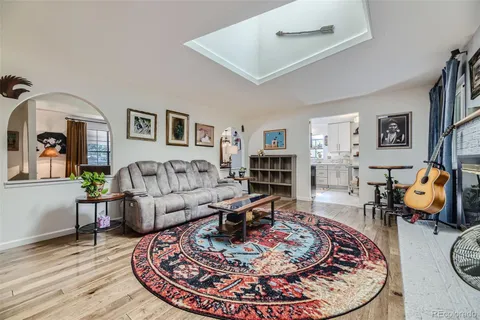 a living room with furniture and a wooden floor