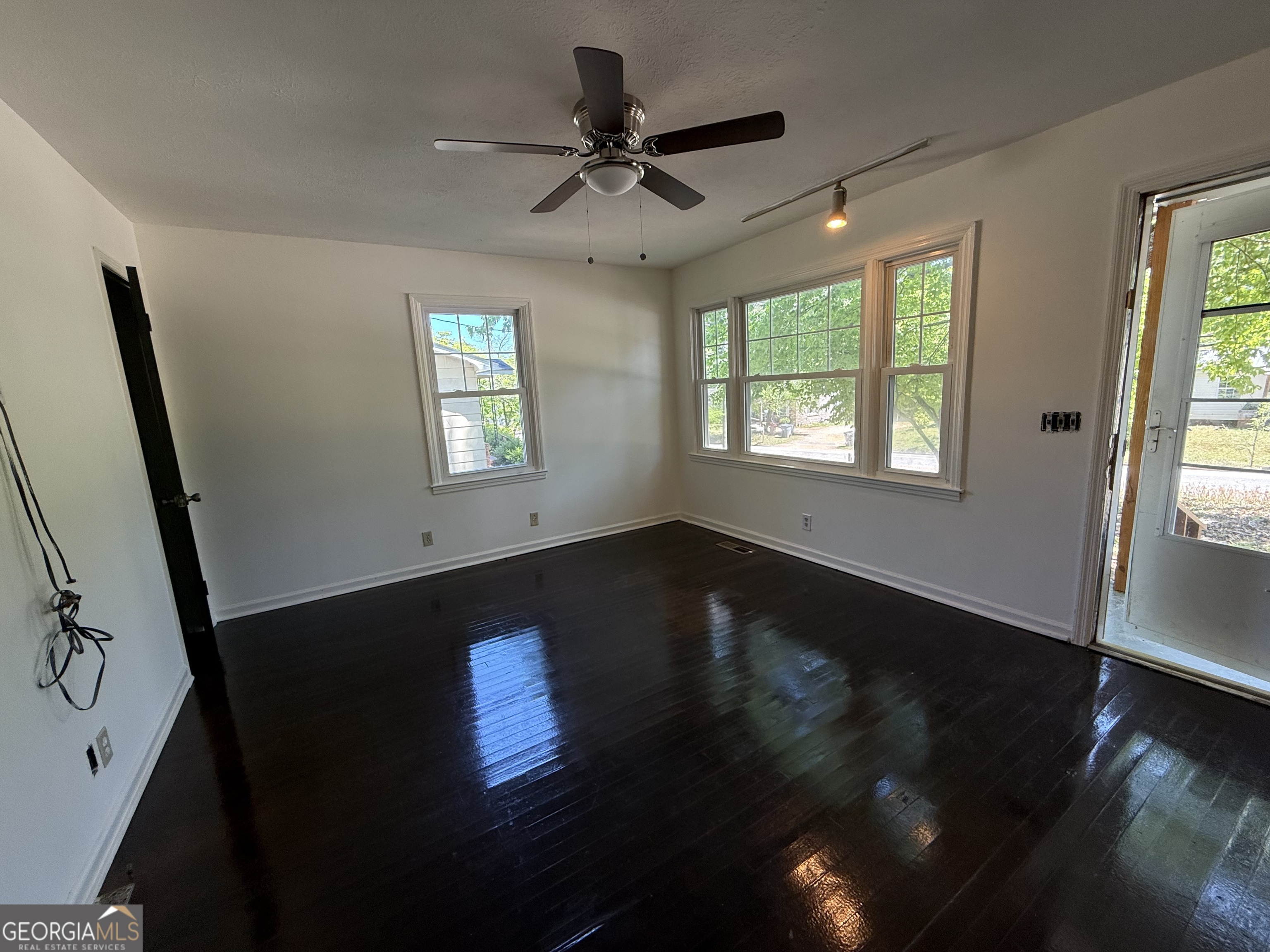 179 Youngs Mill Road LaGrange, GA 30241 - Photo 5 of 30 a view of an empty room with wooden floor and a window