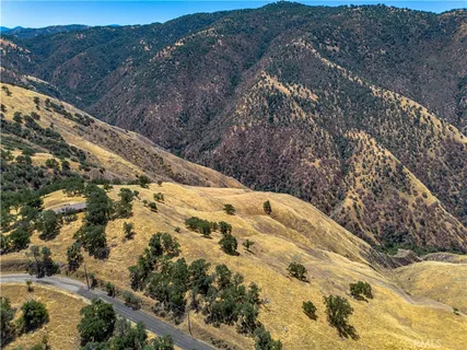 a view of a dry yard with mountains