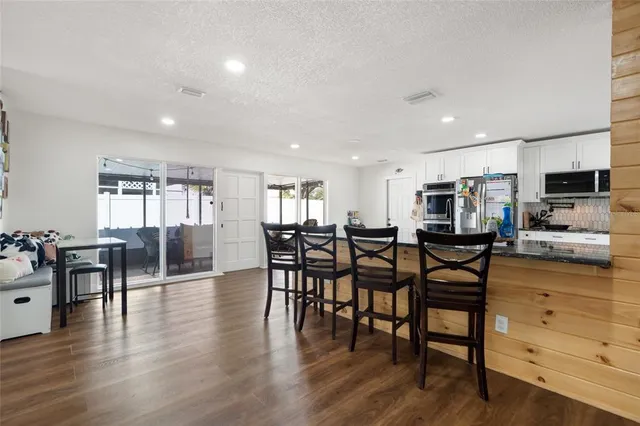 a view of a dining area with furniture window and wooden floor