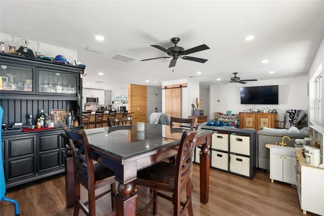 a view of a dining room with furniture and wooden floor