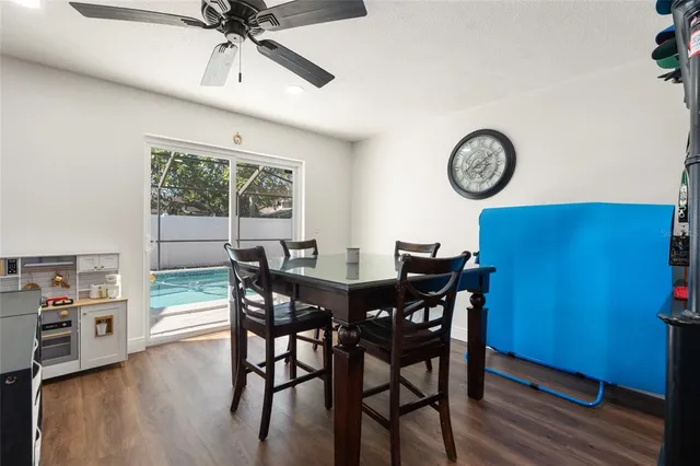 a view of a dining room and livingroom with furniture window and wooden floor