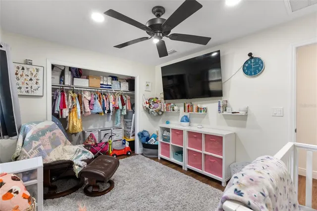a bedroom with bed and a flat tv screen