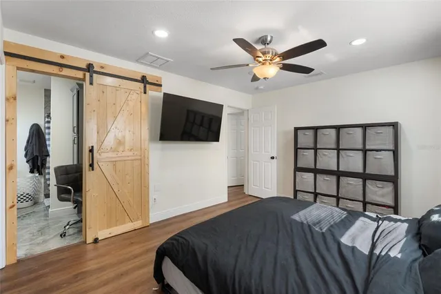 a bedroom with a bed and a flat screen tv