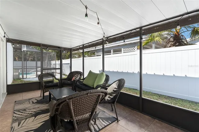 a view of a dining room with furniture large windows and wooden floor