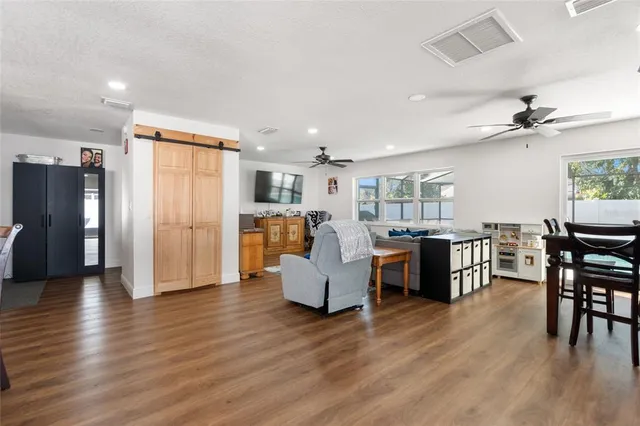 a living room with furniture and kitchen view