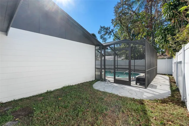 a backyard of a house with table and chairs