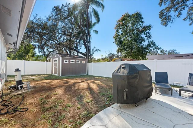 a view of a patio with a table and chairs
