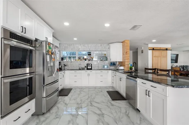 a large kitchen with stainless steel appliances kitchen island granite countertop a large counter top stainless steel appliances and cabinets