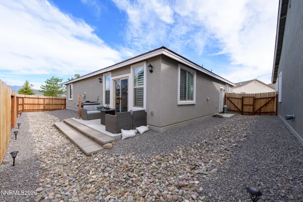 a view of a house with backyard and sitting area