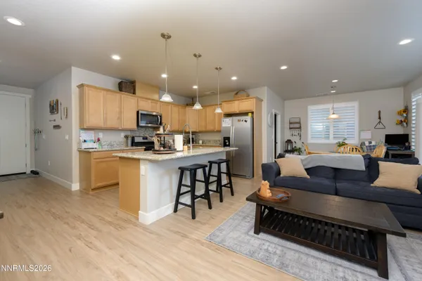 a living room kitchen with furniture and a kitchen view