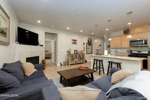 a living room with furniture kitchen a fireplace and a flat screen tv
