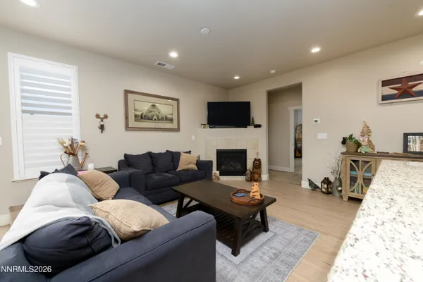 a living room with furniture a rug and a fireplace