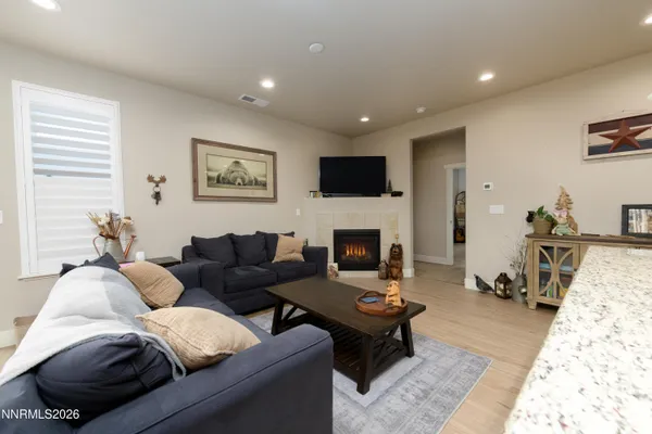 a living room with furniture a rug and a fireplace