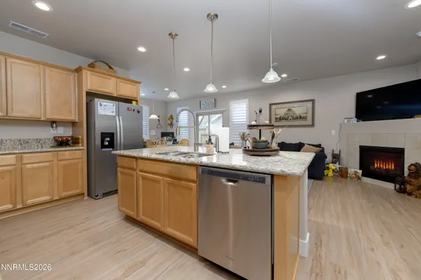 a kitchen with a sink cabinets and wooden floor