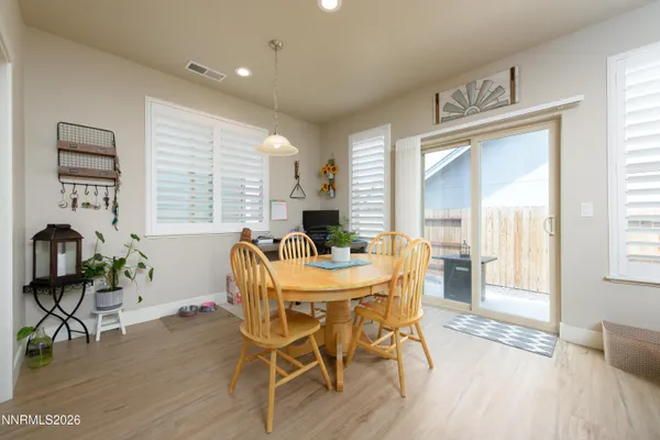 a view of a dining room with furniture window and wooden floor