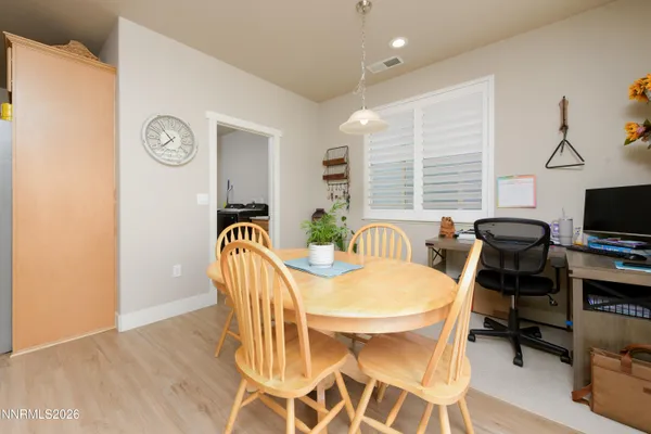 a view of a dining room with furniture window and wooden floor