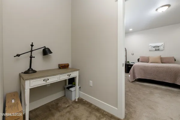 a living room with furniture and a lamp
