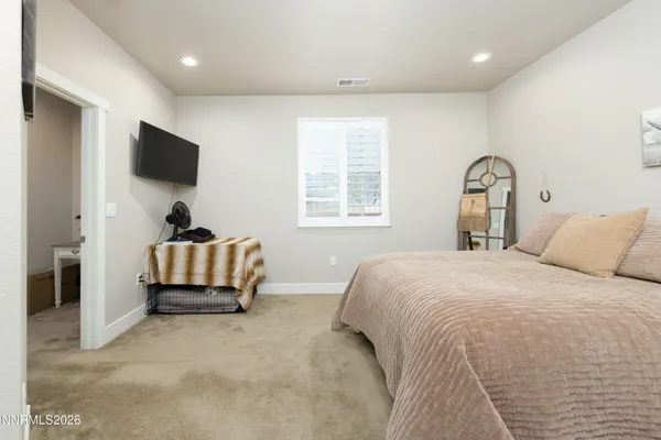 a bedroom with a bed and flat screen tv