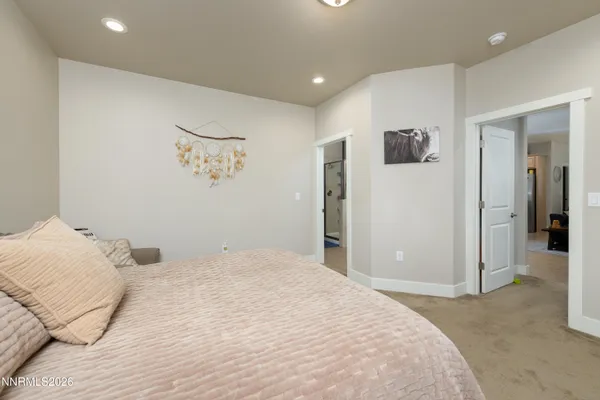 a bedroom with a large bed and a shower