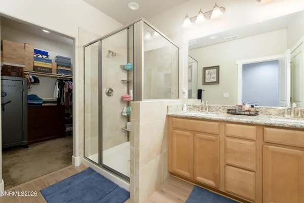 a bathroom with a shower sink and mirror