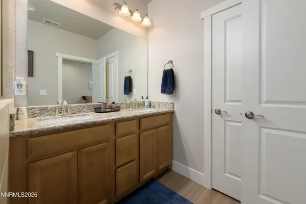 a bathroom with a double vanity sink and mirror