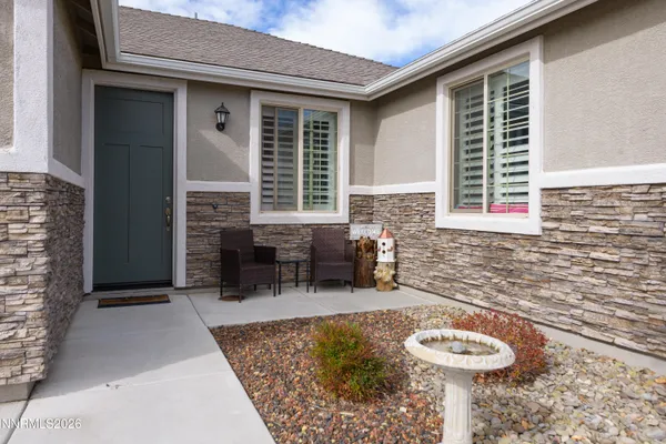 a front view of a house with outdoor seating
