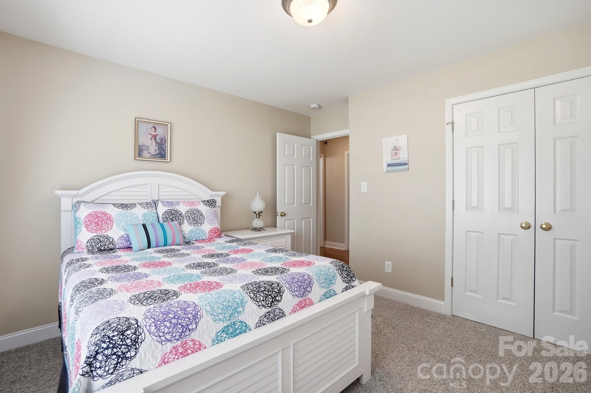 3324 Muddy Creek Road Midland, NC 28107 - Photo 37 of 46 a bedroom with a large bed and a chandelier