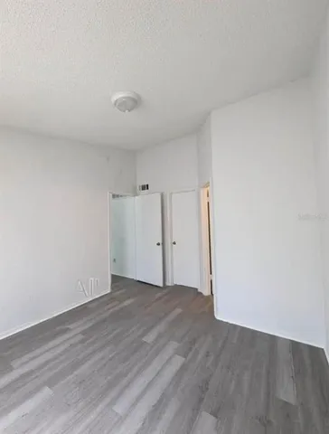 an empty room with wooden floor