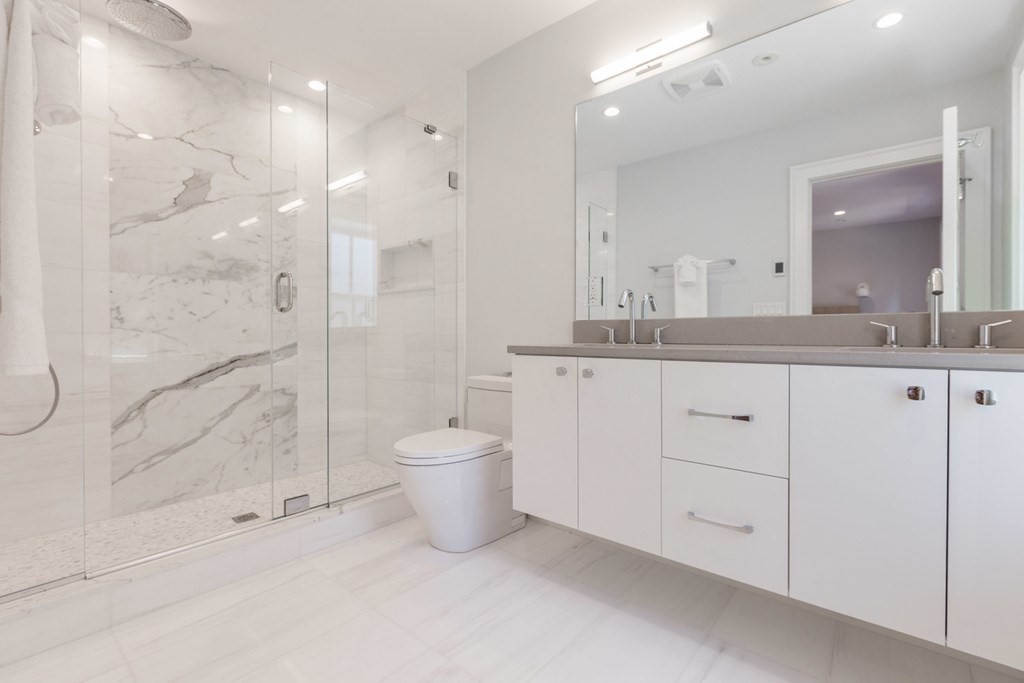 44 Upton Street, Unit 1 Boston, MA 02118 - Photo 17 of 35 a bathroom with a granite countertop sink mirror and a bathtub