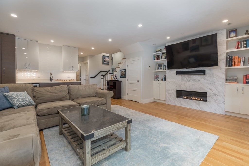 44 Upton Street, Unit 1 Boston, MA 02118 - Photo 20 of 35 a living room with furniture a flat screen tv and a fireplace