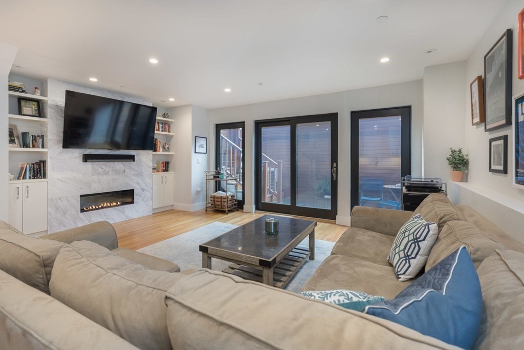 44 Upton Street, Unit 1 Boston, MA 02118 - Photo 24 of 35 a living room with furniture fireplace and flat screen tv