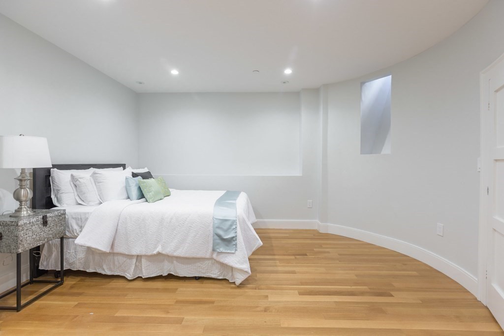 44 Upton Street, Unit 1 Boston, MA 02118 - Photo 26 of 35 a bedroom with a bed and a night stand