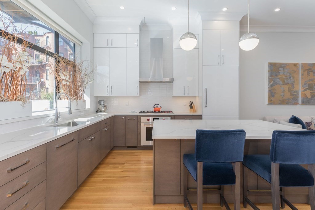 44 Upton Street, Unit 1 Boston, MA 02118 - Photo 5 of 35 a kitchen with a sink white cabinets and wooden floor
