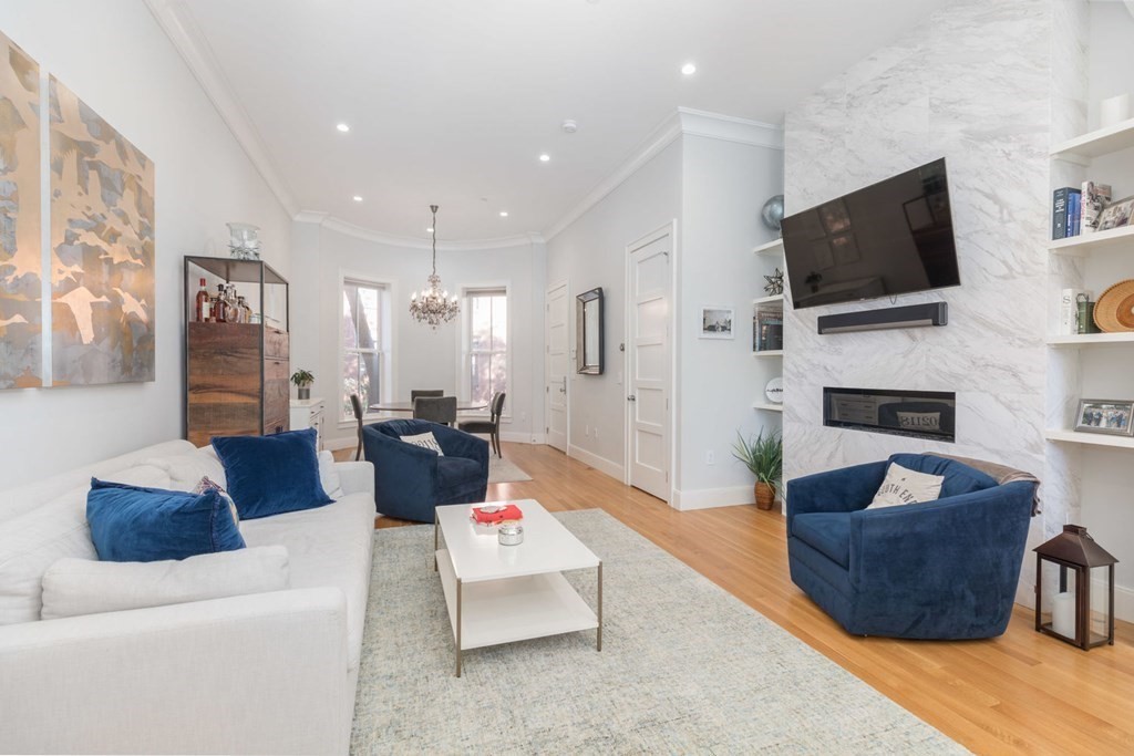44 Upton Street, Unit 1 Boston, MA 02118 - Photo 7 of 35 a living room with fireplace furniture and a flat screen tv
