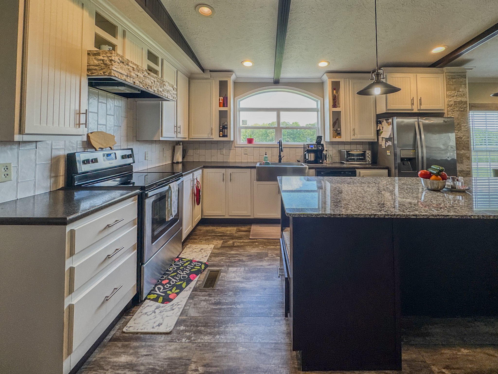 1198 David Patterson Road Lutts, TN 38471 - Photo 14 of 82 a large kitchen with stainless steel appliances granite countertop a stove a sink dishwasher and cabinets with wooden floor