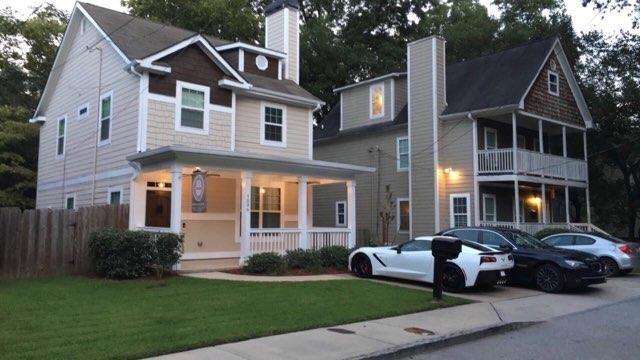 a front view of a house with a garden
