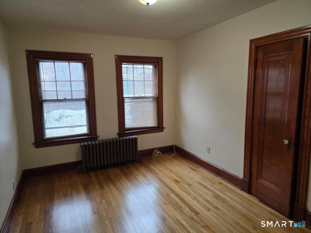 39 Starview Avenue Waterbury, CT 06708 - Photo 5 of 8 an empty room with wooden floor and windows